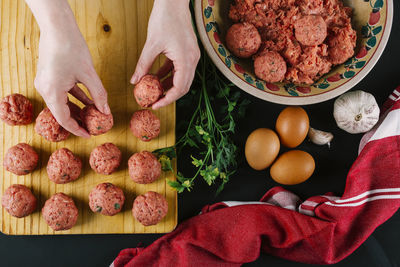 Woman makes homemade meatballs with minced meat seasoned with spices