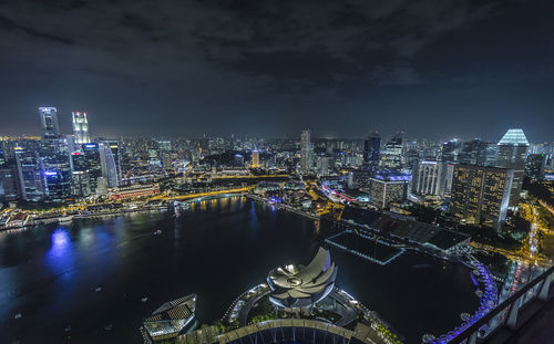 High angle view of illuminated cityscape against sky at night