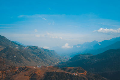 Scenic view of mountains against cloudy sky