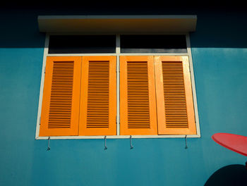 Low angle view of yellow window on building