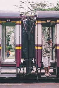 Rear view of woman standing by train