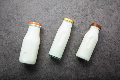 Directly above shot of bottles on gray table