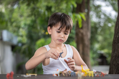 Boy playing with toys outdoors