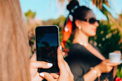 Happy girlfriends taking photo on vacation concept of friendship and fun in the summer technology 