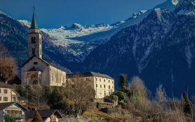 Panoramic view of buildings and mountains against sky