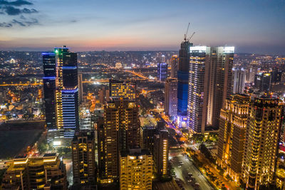 High angle view of illuminated buildings in city at night