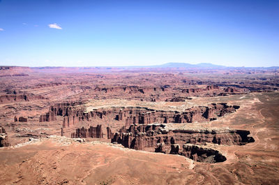 Aerial view of rock formations against blue sky