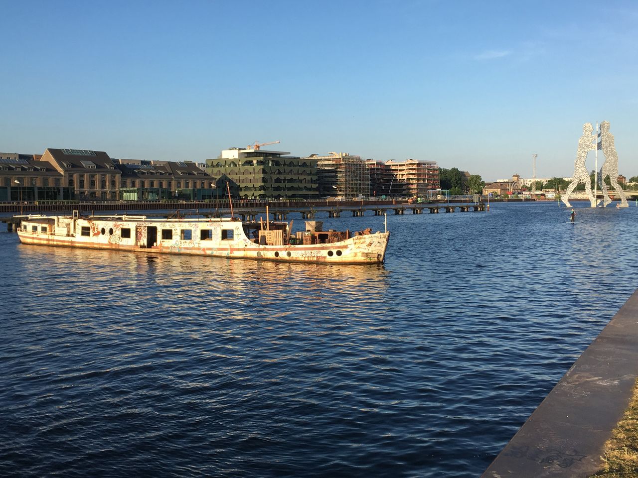 architecture, water, built structure, building exterior, city, sky, nautical vessel, transportation, mode of transportation, waterfront, nature, river, day, building, clear sky, no people, outdoors, blue, passenger craft