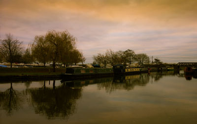 Scenic view of lake against sky at sunset