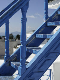 Close-up of bridge against blue sky