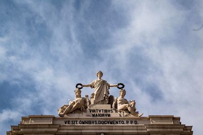 Low angle view of statue against cloudy sky