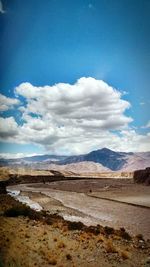 Scenic view of mountains against cloudy sky