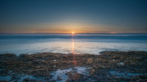 Scenic view of sea against sky during sunset