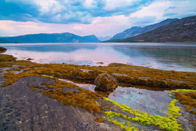 Scenic view of lake and mountains against sky