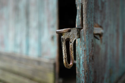 Close-up of latch on old wooden door