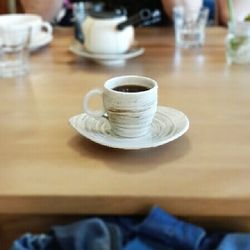 Close-up of coffee cup on wooden table