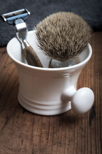 Close-up of shaving equipment on table