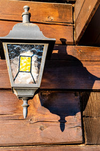 Close-up of electric lamp on wooden table