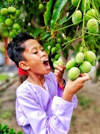 Boy holding fruits