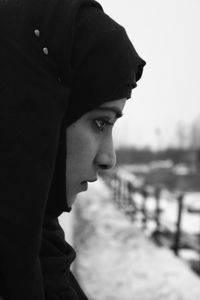 Close-up of thoughtful woman looking away during winter