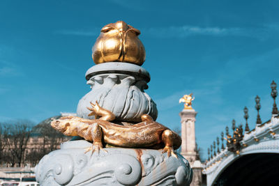 Low angle view of statue against sky