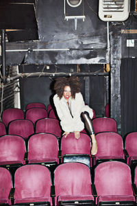 Portrait of young woman sitting on chair