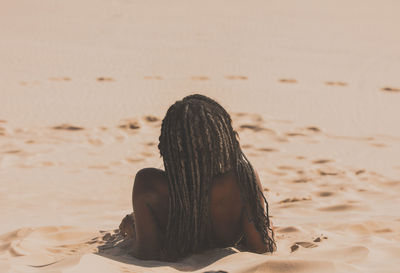 Close-up of women sitting on beach