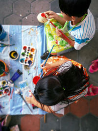 High angle view of children painting outdoors