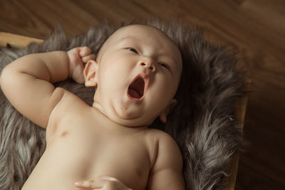 High angle view of baby lying on bed