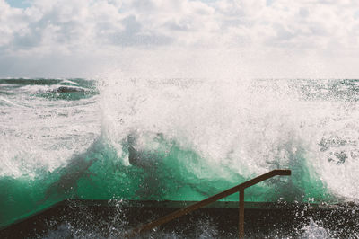 Close-up of waves in sea against sky