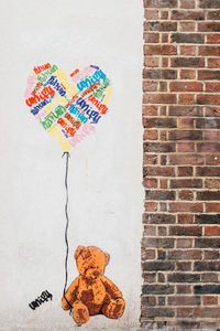 Multi colored clothes hanging on wall