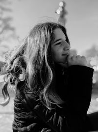 Woman looking away against sky