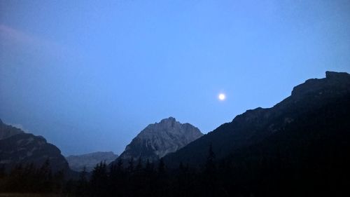 Scenic view of mountains against clear sky at night