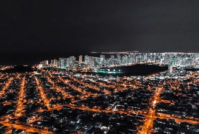 High angle view of illuminated buildings in city at night