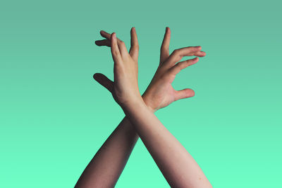 Woman's hands against green background