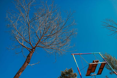 Low angle view of basketball hoop against blue sky