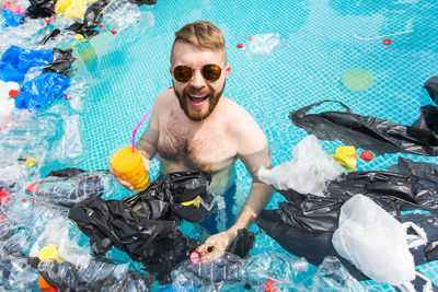 Portrait of smiling young man swimming pool