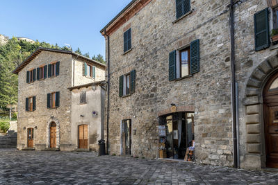 Old building by street in town