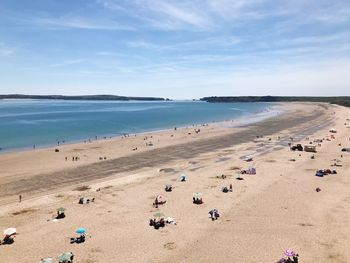 Group of people on beach against sky
