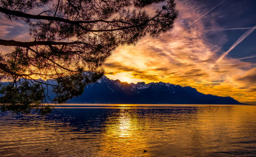 Scenic view of lake against romantic sky at sunset