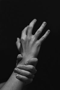 Close-up of hands over black background