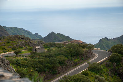 High angle view of road by mountains against sky