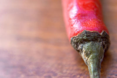 Close up of red chili pepper on wooden table