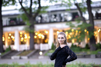 Portrait of a cute and gorgeous young woman on blurred street background with bokeh light