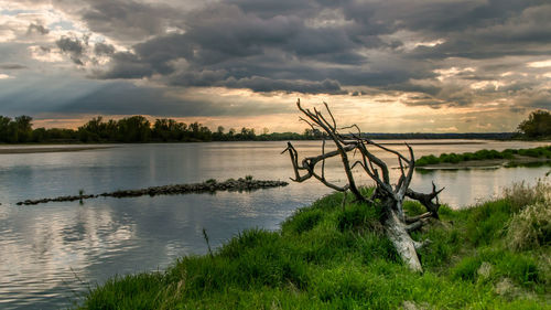 Scenic view of lake against sky during sunset