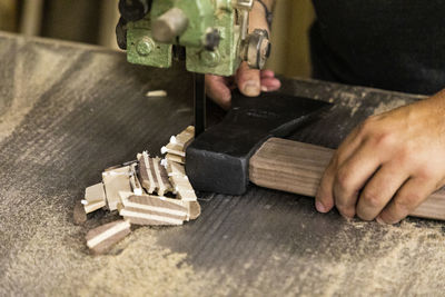 Midsection of man working at workshop