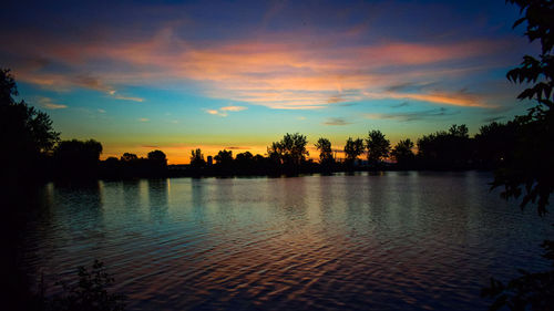 Scenic view of lake against sky during sunset