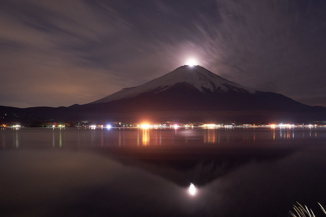 mountain, water, night, sky, reflection, illuminated, dawn, beauty in nature, nature, scenics - nature, no people, horizon, travel destinations, light, lake, architecture, evening, city, tranquility, landscape, outdoors, cloud, long exposure, land, environment, volcano, tranquil scene, travel, mountain range, built structure, darkness