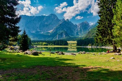 Scenic view of lake and mountains against sky