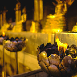 Close-up of burning candles in temple